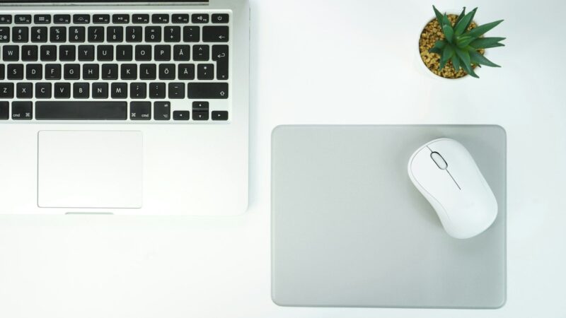macbook pro beside apple magic mouse