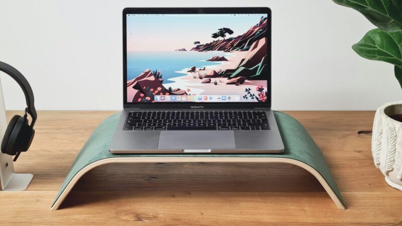 a laptop computer sitting on top of a wooden desk